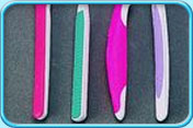 Photograph of several toothbrushes with slip prevention grip handles.