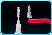 Photograph of two different sizes of interdental brush heads.