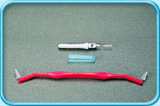 Photograph of two interdental brushes with long and short handles.