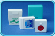 Photograph of a few boxes of mint flavoured floss.