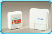 Photograph of two boxes of fluoride coated floss.