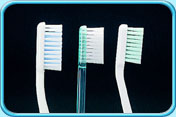 Photograph of several tooth brush heads in block pattern.