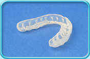Photograph of a partially translucent mouth guard.